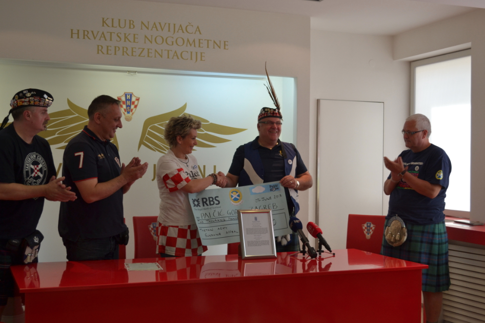 Neil Forbes of the Tartan Army Sunshine Appeal presents a cheque for £2000 to Željka Vučko of Palčić Gore